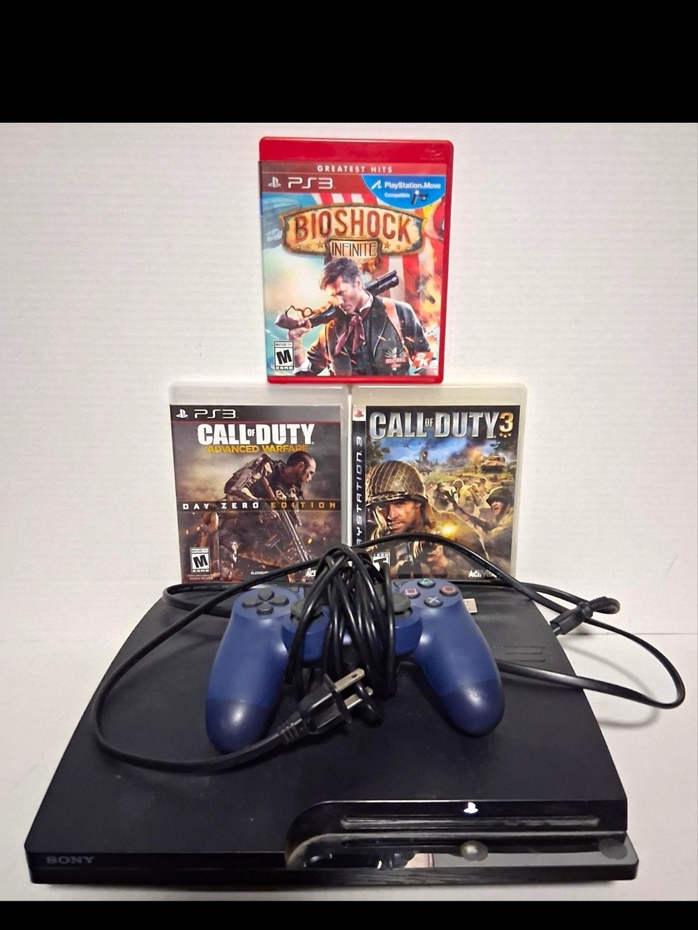 Sony PS3 Slim Console with Blue Controller and 3 Game Titles